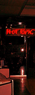 Photography of the outside of a Hot Topic. It is very dark.