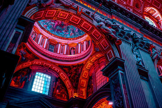 Photography of The Vatican in red lighting.